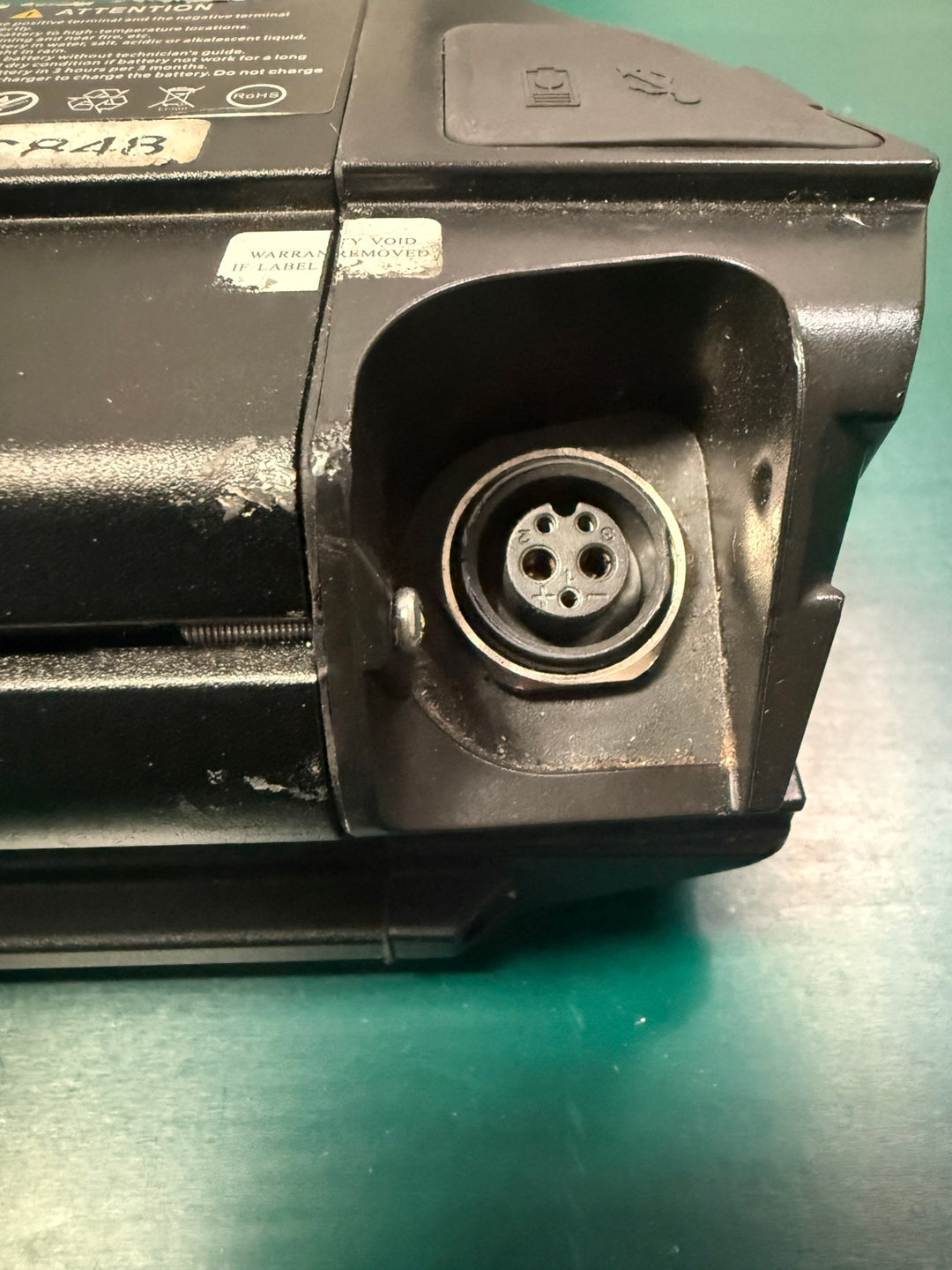 Used Reention Dorado MAX eBike battery charging connector close-up
